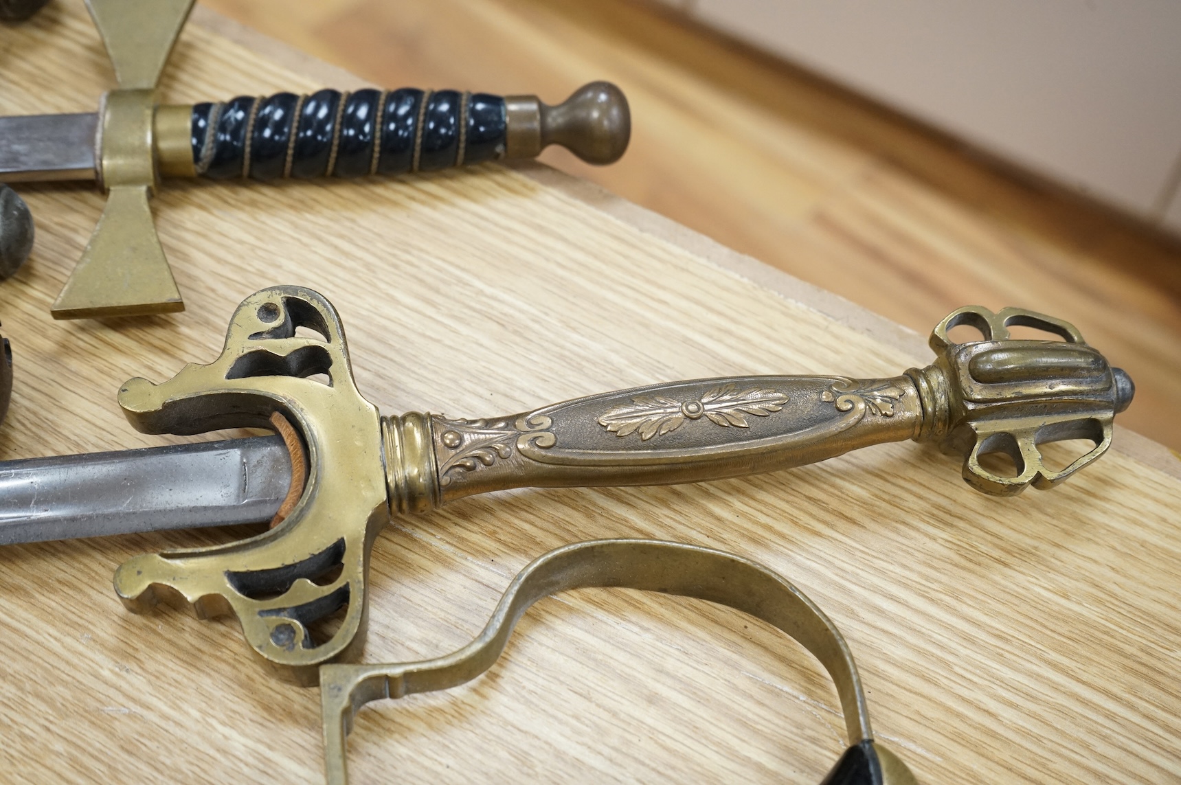 An Imperial German presentation infantry officer’s sword dated 1919/20, another similar with plain blade and brass stirrup hilt, another similar, plain in steel scabbard, a Wilkinson masonic sword probably circa 1950, a